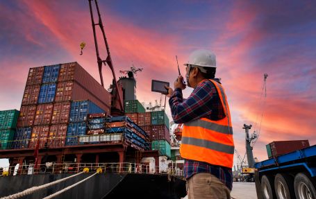 a man at the port of maritime and AI, speaking on the radiophone.