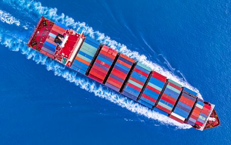 shipping port vessel running across the sea towards south east