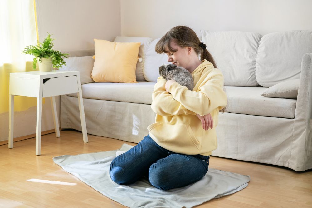 A girl holding pet rabbit