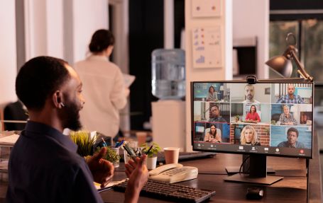 a man attending a meeting a conference video call working remotely