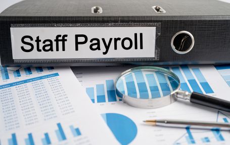 staff payroll file , pen and a microscope with new salary slips