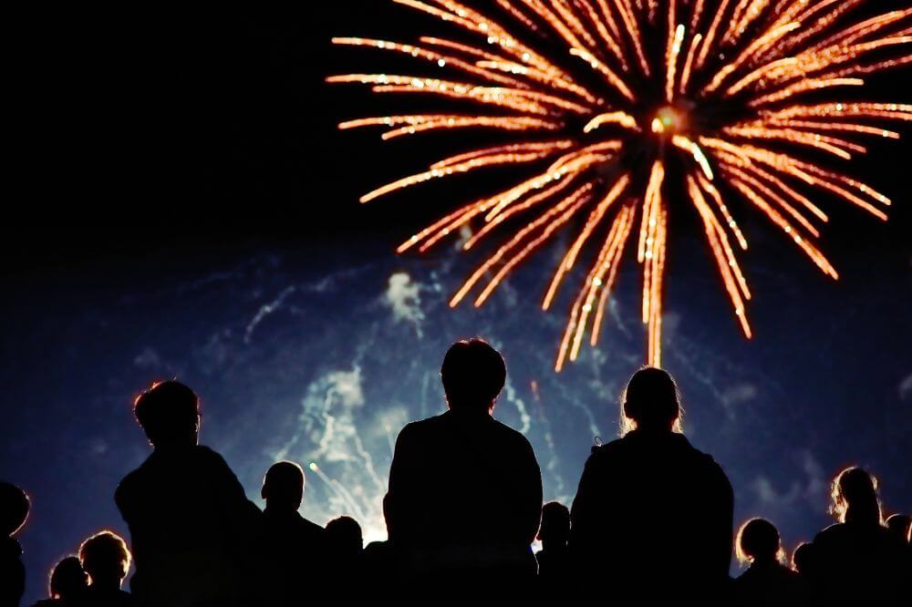 An image of people getting involved in fireworks night in their community 