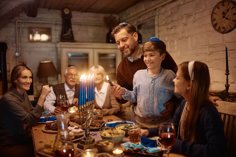 Image of a family lighting a menorah