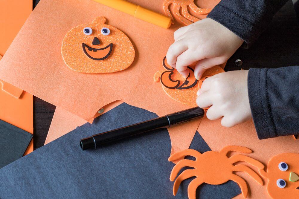 An image of a child making DIY Halloween decorations